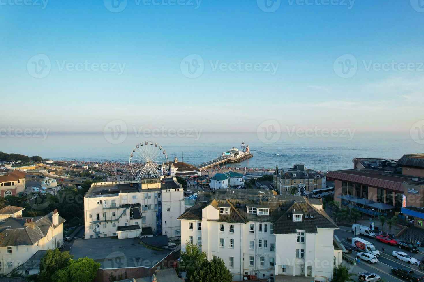 Aerial View of British Tourist Attraction of Bournemouth Beach and Sea view City of England Great Britain UK. Image Captured with Drone's Camera on September 9th, 2023 During Sunset photo