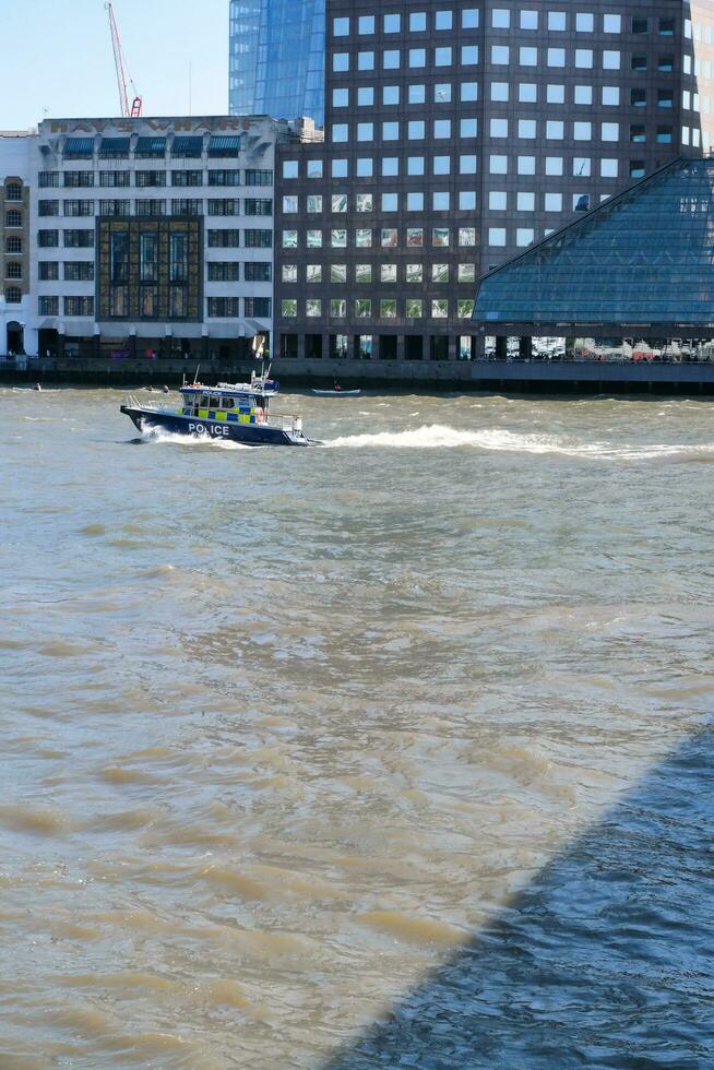Best View of Boat over River Thames Waters at London Bridge, Capital City of England Great Britain. The Image Was Captured June 4th, 2023 photo