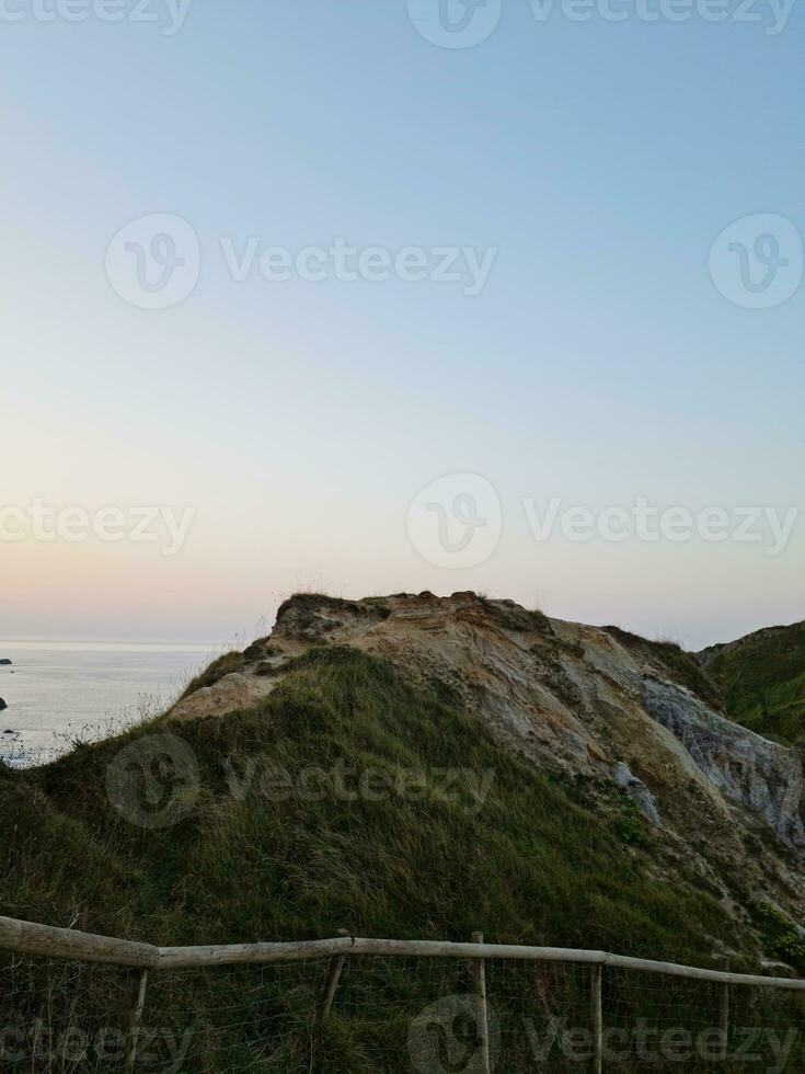 High Angle View of People are Approaching to Durdle Door Beach Which is Most Famous Tourist Attraction Place Through Walking Distance over Landscape and Hills. Captured on September 9th, 2023 photo