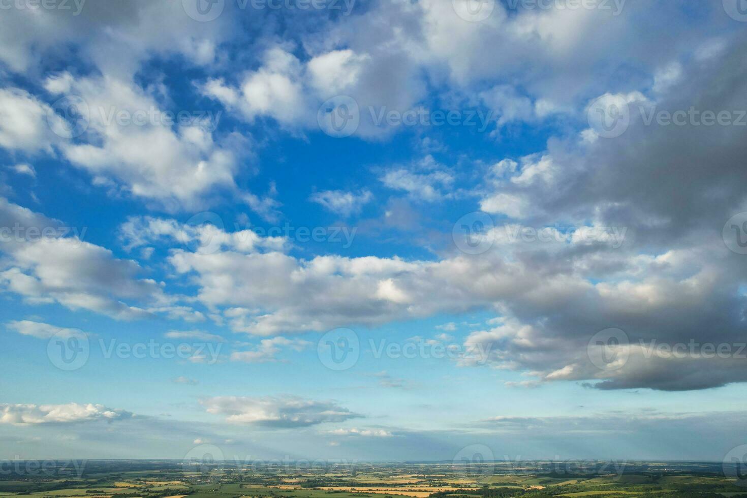 Most Beautiful High Angle view of Dramatical Sky and Clouds over British Countryside Landscape During Sunset photo