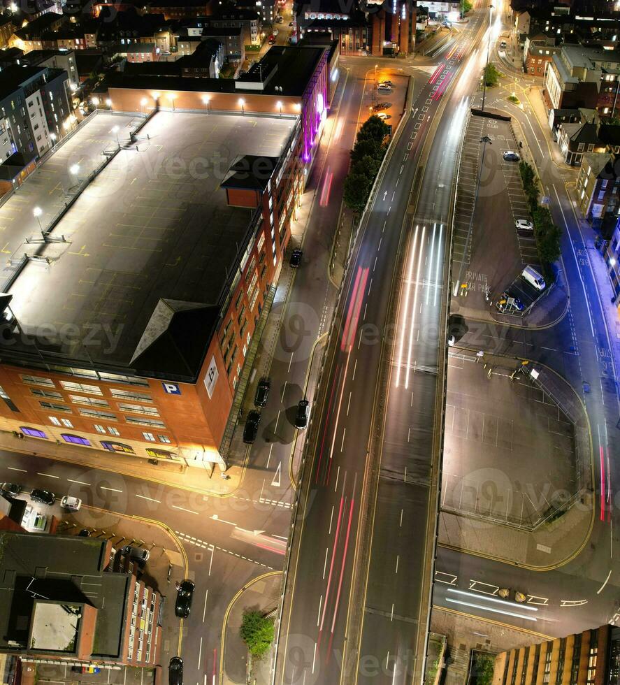 Aerial Vertical Panoramic View of Illuminated Downtown Buildings, Roads and Central Luton City of England UK at Beginning of Clear Weather's Night of September 5th, 2023 photo