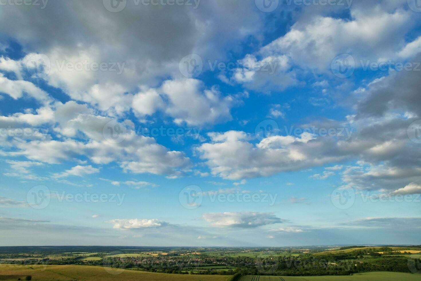Most Beautiful High Angle view of Dramatical Sky and Clouds over British Countryside Landscape During Sunset photo
