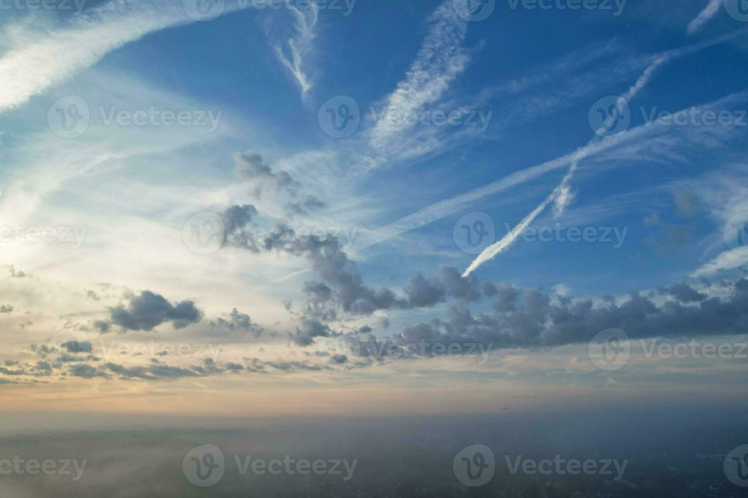 Most Beautiful and Best High Angle Dramatical Colourful Sky Footage from Above The Clouds. The Fast Moving Clouds During Sun rising Early in the Morning over Luton City of England UK photo