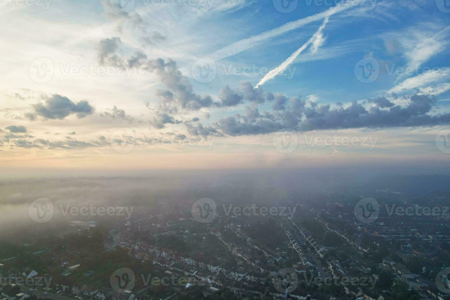 Most Beautiful and Best High Angle Dramatical Colourful Sky Footage from Above The Clouds. The Fast Moving Clouds During Sun rising Early in the Morning over Luton City of England UK photo