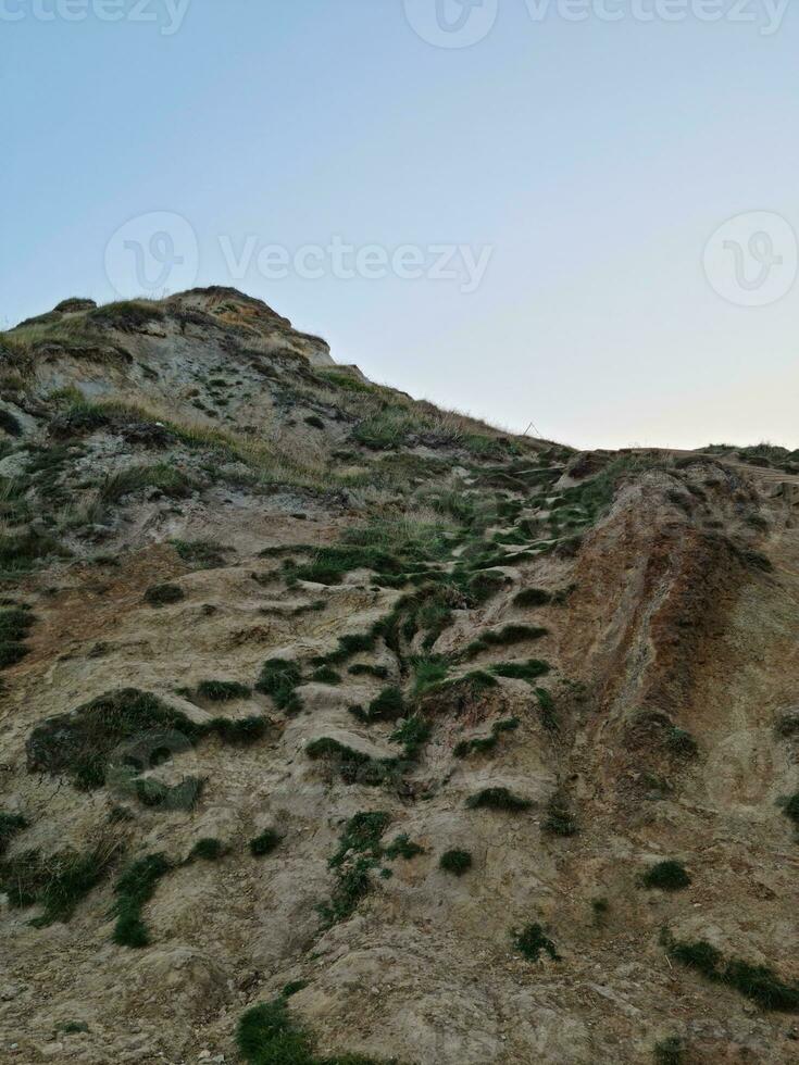 High Angle View of People are Approaching to Durdle Door Beach Which is Most Famous Tourist Attraction Place Through Walking Distance over Landscape and Hills. Captured on September 9th, 2023 photo