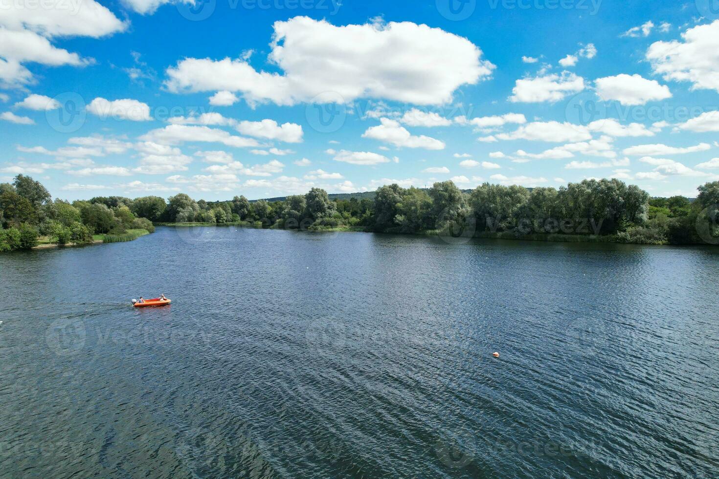 High Angle footage of People are Boating at Caldecotte Lake Located at Milton Keynes City of England Great Britain UK. The Aerial Landscape Was Captured on August 21st, 2023 with Drone's Camera photo