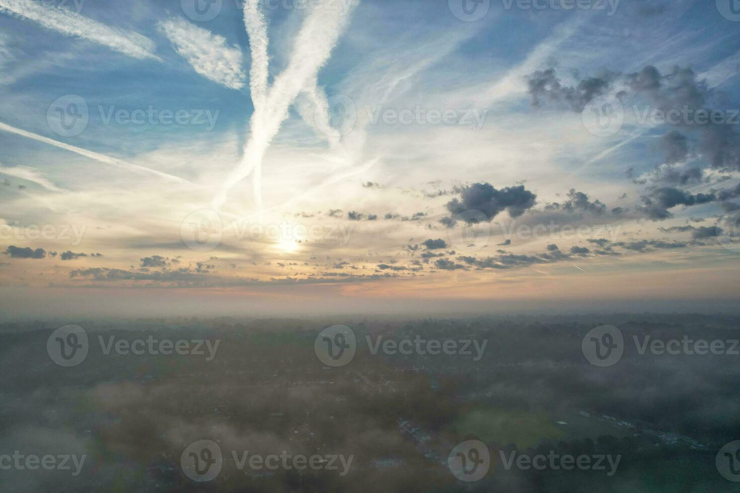 Most Beautiful and Best High Angle Dramatical Colourful Sky Footage from Above The Clouds. The Fast Moving Clouds During Sun rising Early in the Morning over Luton City of England UK photo