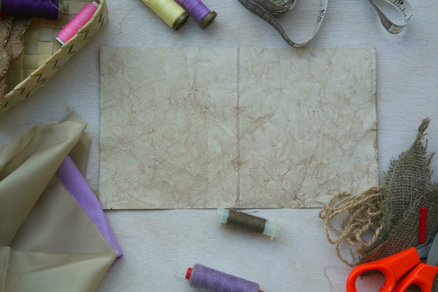 a basket with scissors, thread, and paper photo