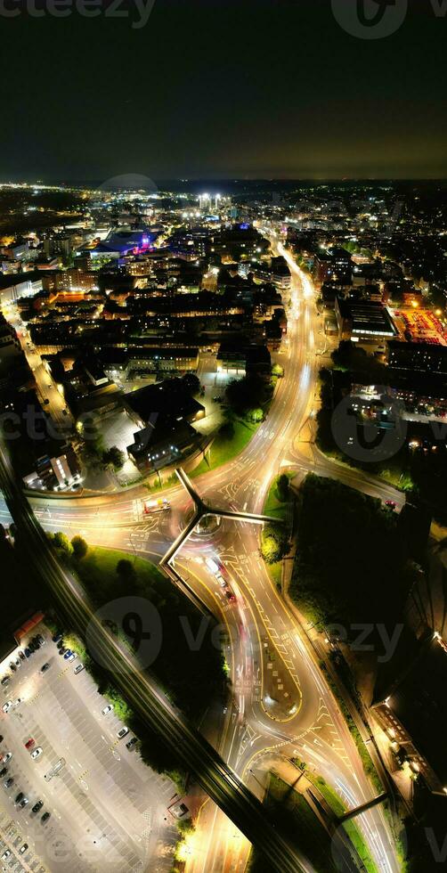 Aerial Vertical Panoramic View of Illuminated Downtown Buildings, Roads and Central Luton City of England UK at Beginning of Clear Weather's Night of September 5th, 2023 photo