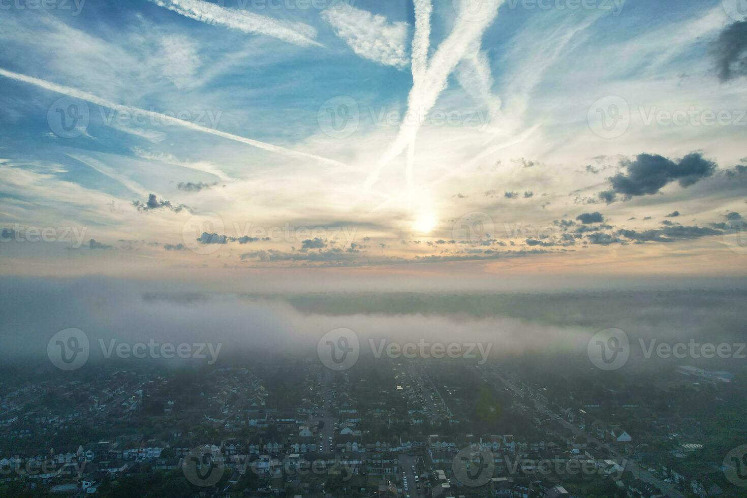 Most Beautiful and Best High Angle Dramatical Colourful Sky Footage from Above The Clouds. The Fast Moving Clouds During Sun rising Early in the Morning over Luton City of England UK photo