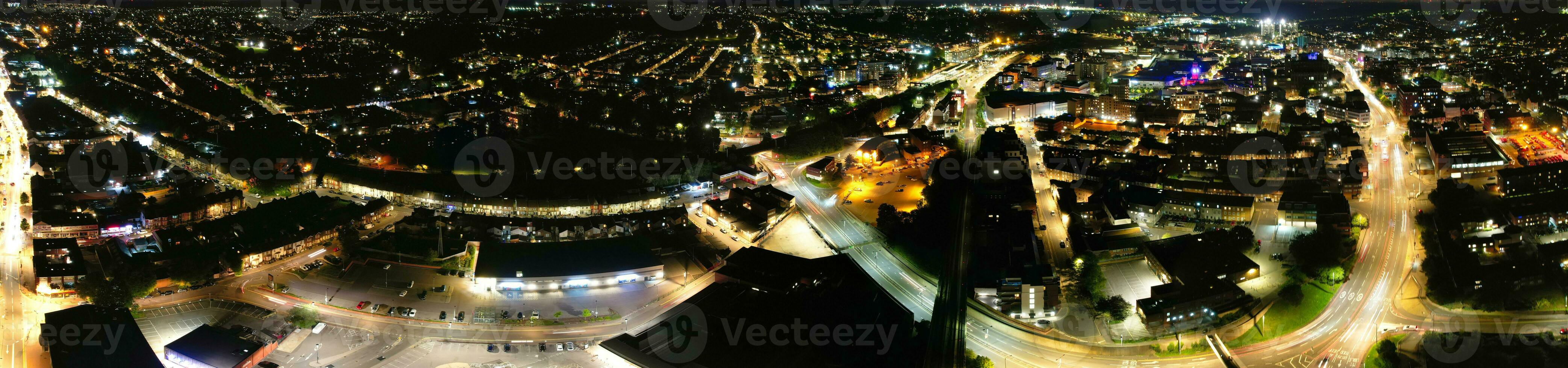 Ultra Wide Aerial Panoramic View of Illuminated Downtown Buildings, Roads and Central Luton City of England UK at Beginning of Clear Weather's Night of September 5th, 2023 photo