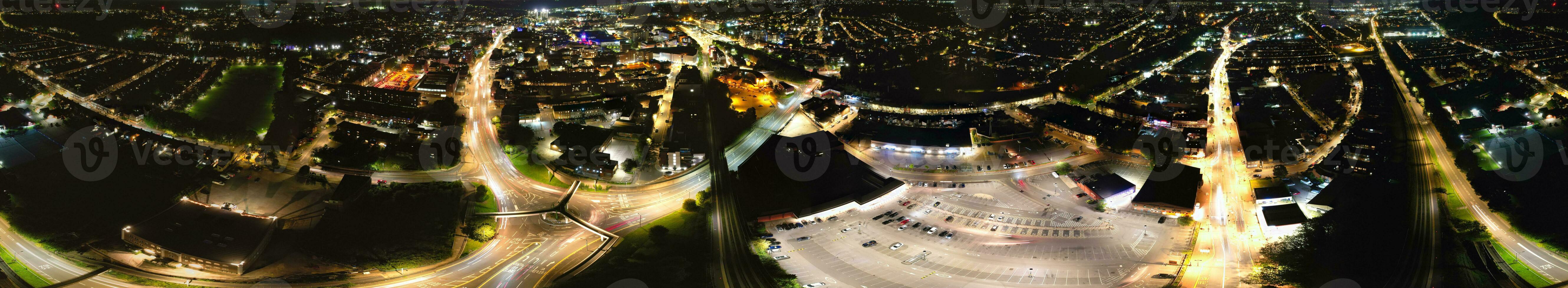 Ultra Wide Aerial Panoramic View of Illuminated Downtown Buildings, Roads and Central Luton City of England UK at Beginning of Clear Weather's Night of September 5th, 2023 photo