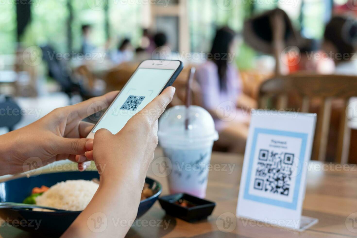 Woman use smartphone to scan QR code for order menu in cafe restaurant with a digital delivery. Choose menu and order accumulate discount. E wallet, technology, pay online, credit card, bank app. photo
