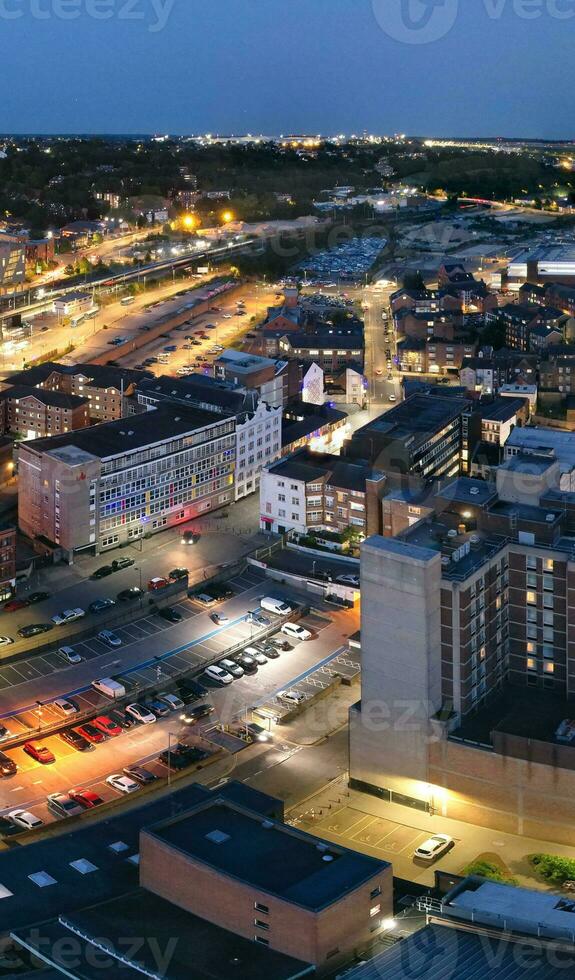 Aerial Vertical Panoramic View of Illuminated Downtown Buildings, Roads and Central Luton City of England UK at Beginning of Clear Weather's Night of September 5th, 2023 photo