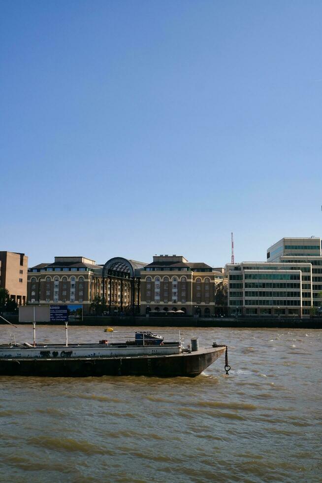 Best View of Boat over River Thames Waters at London Bridge, Capital City of England Great Britain. The Image Was Captured June 4th, 2023 photo