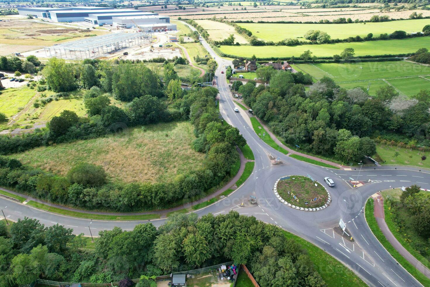 High Angle Footage of British Road and Traffic at Caldecotte Lake of Milton Keynes City of England Great Britain, Beautiful View Captured on August 21st, 2023 with Drone's Camera During Sunny Day photo