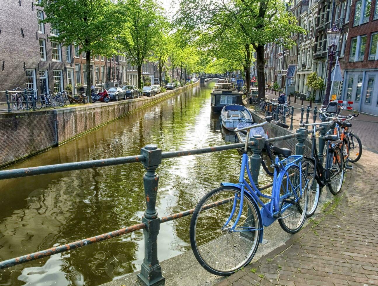 Typical canal and bikes in Amsterdam, Netherlands photo