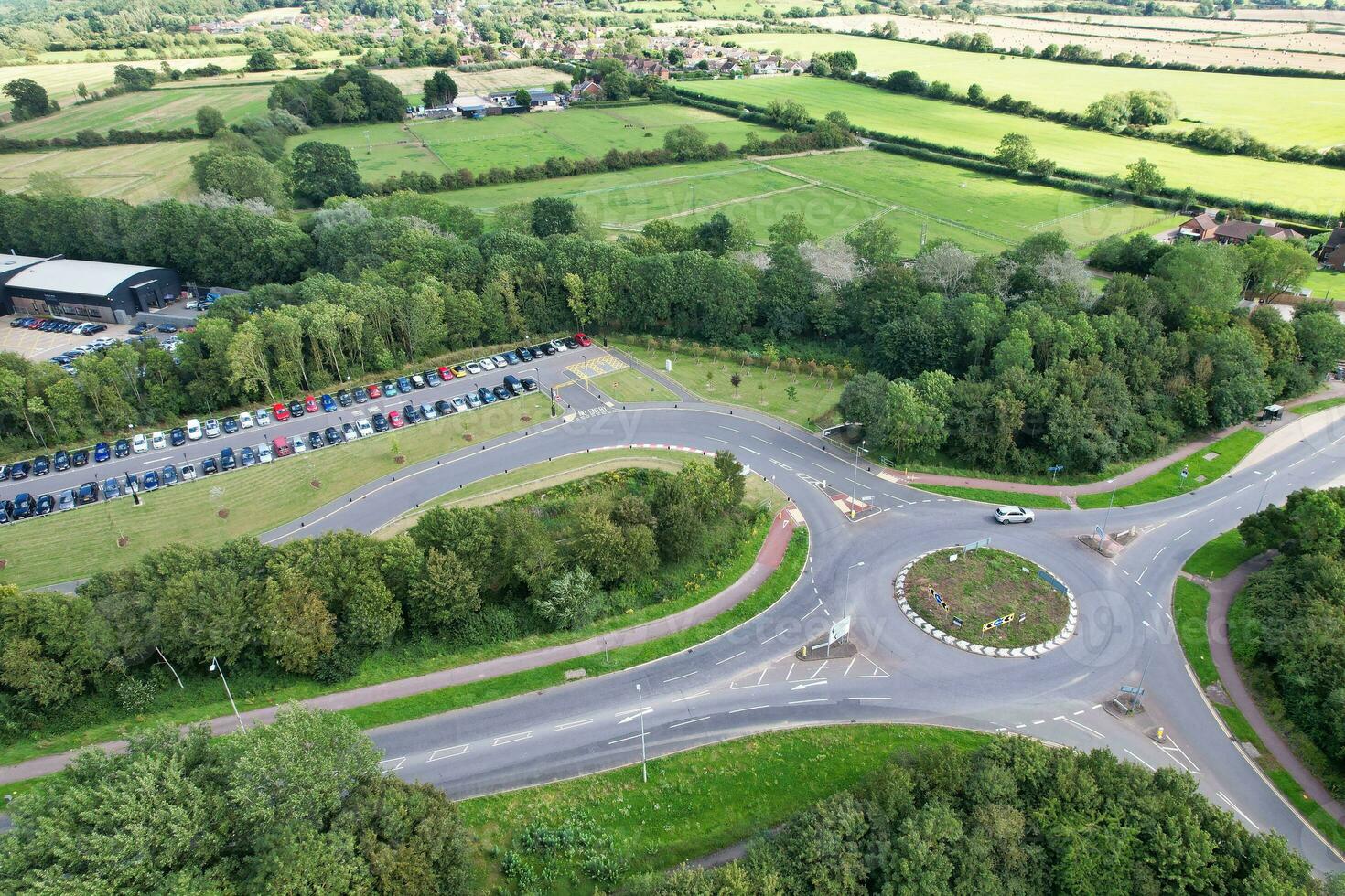 High Angle Footage of British Road and Traffic at Caldecotte Lake of Milton Keynes City of England Great Britain, Beautiful View Captured on August 21st, 2023 with Drone's Camera During Sunny Day photo