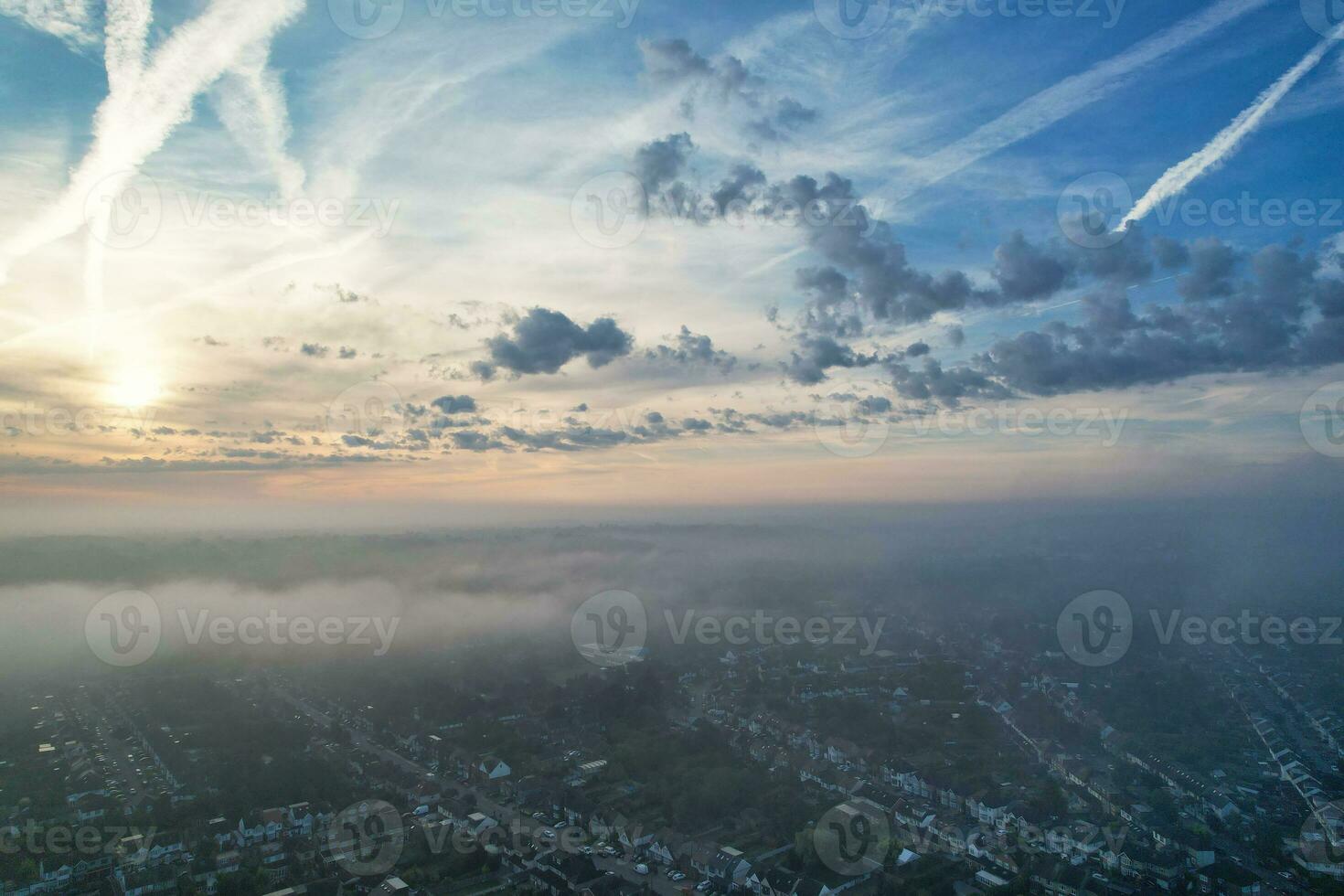 Most Beautiful and Best High Angle Dramatical Colourful Sky Footage from Above The Clouds. The Fast Moving Clouds During Sun rising Early in the Morning over Luton City of England UK photo