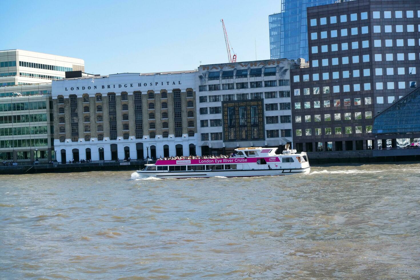Best View of Boat over River Thames Waters at London Bridge, Capital City of England Great Britain. The Image Was Captured June 4th, 2023 photo