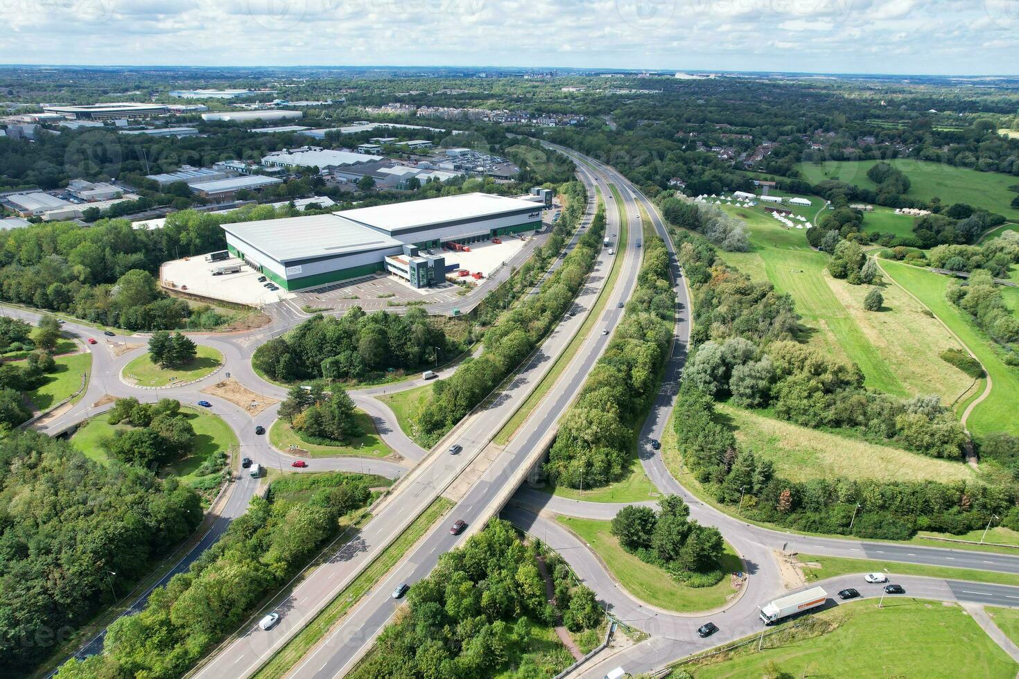 High Angle Footage of British Road and Traffic at Caldecotte Lake of Milton Keynes City of England Great Britain, Beautiful View Captured on August 21st, 2023 with Drone's Camera During Sunny Day photo