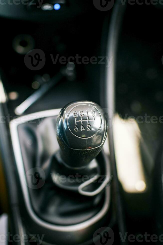 Gear lever of a vehicle. Close-up of a car gear lever, Close up of a car gear knob. Detail view of a vehicle transmission lever photo