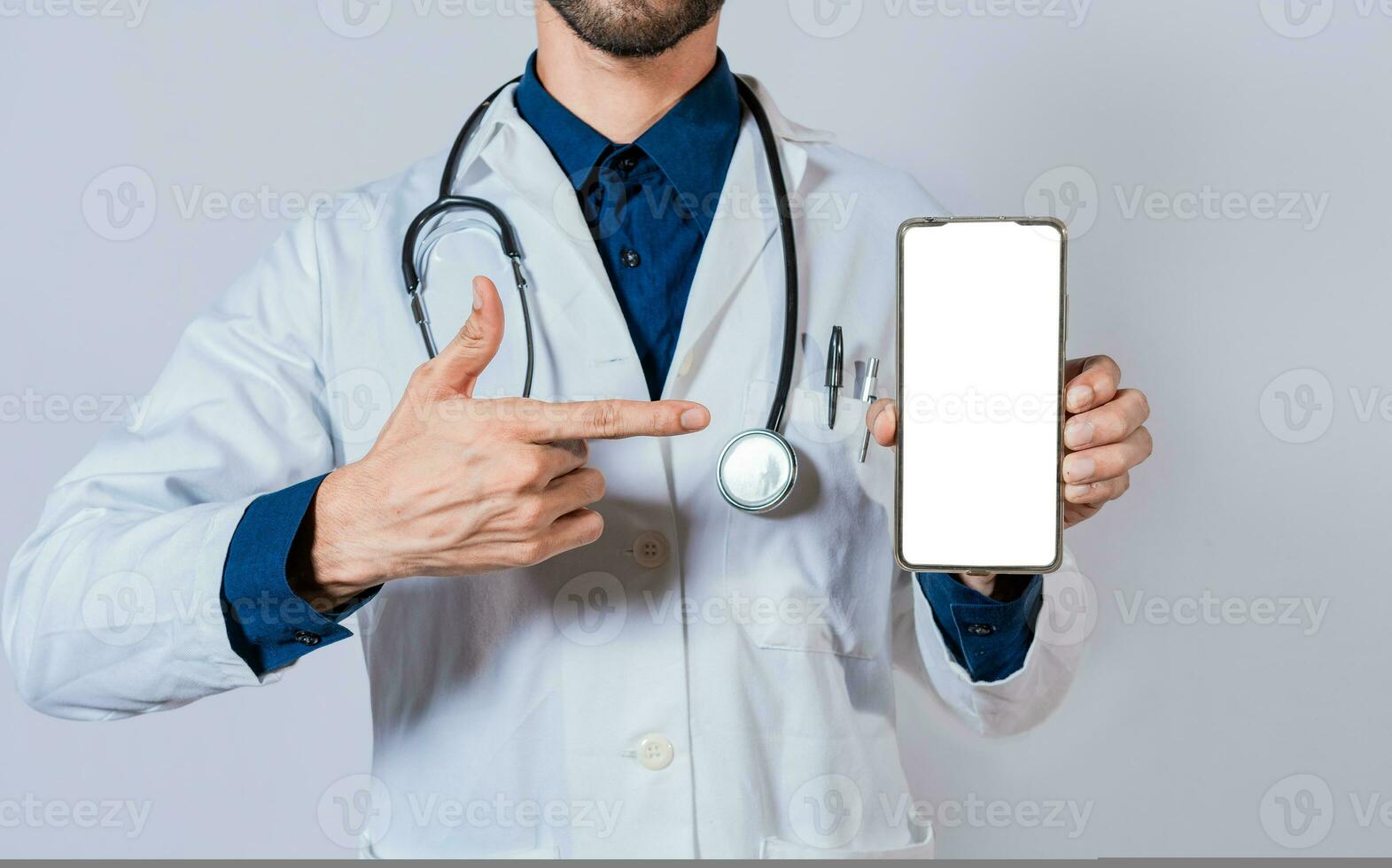 Doctor showing and pointing to blank cell phone screen. Doctor recommending on cell phone screen isolated photo