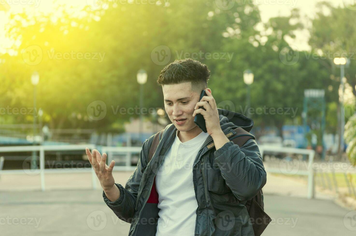 Man calling on the phone, young man calling on cell phone, latin guy calling on the phone photo