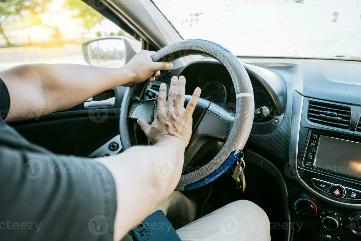 Driver man honking car horn. Close-up of driver honking car horn. Hand of angry driver honking car horn. Concept of impatient driver honking car horn photo