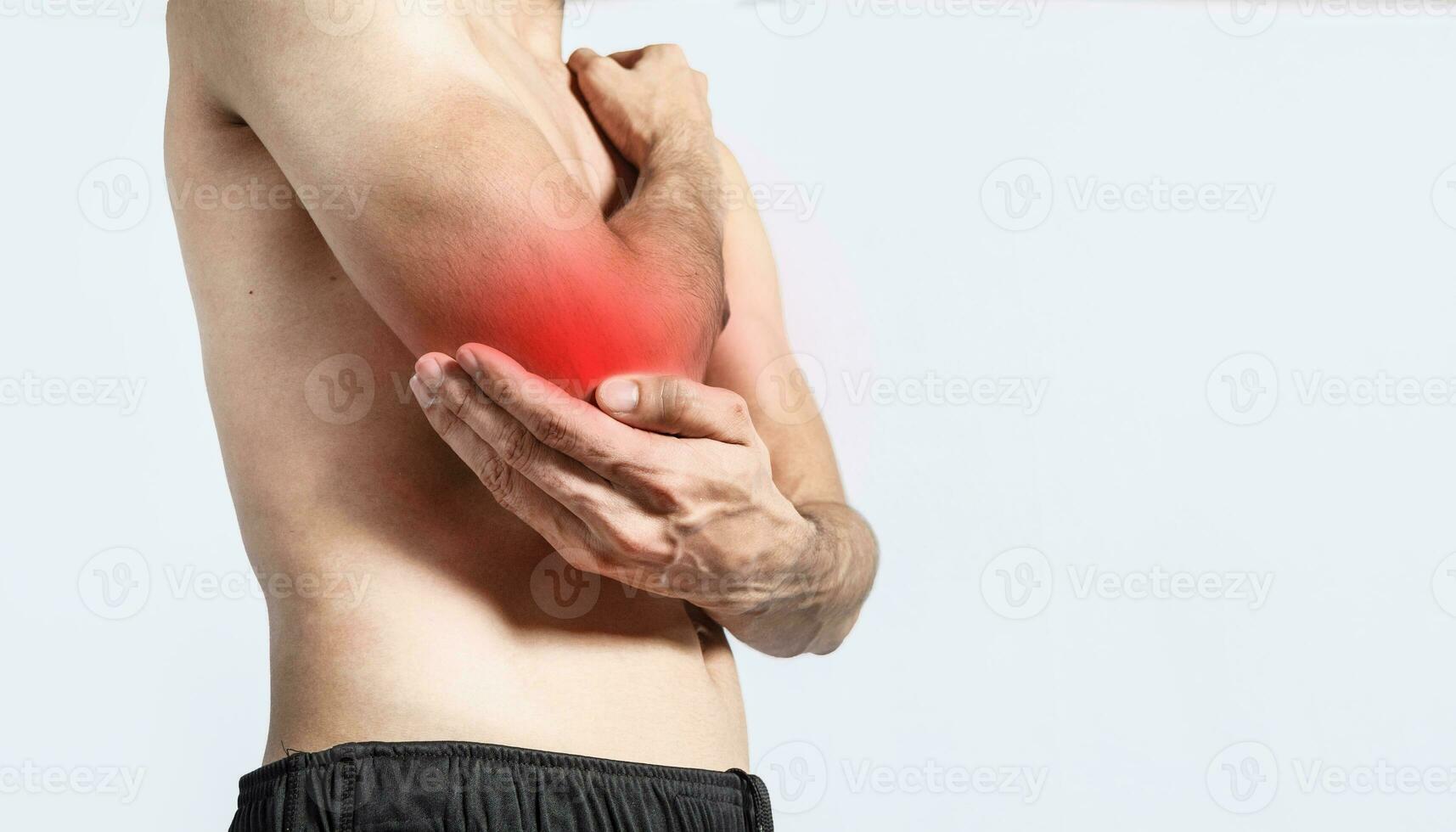 Person with elbow pain, concept of a man with rheumatism elbow pain, man massaging sore elbow, man with elbow cramp photo