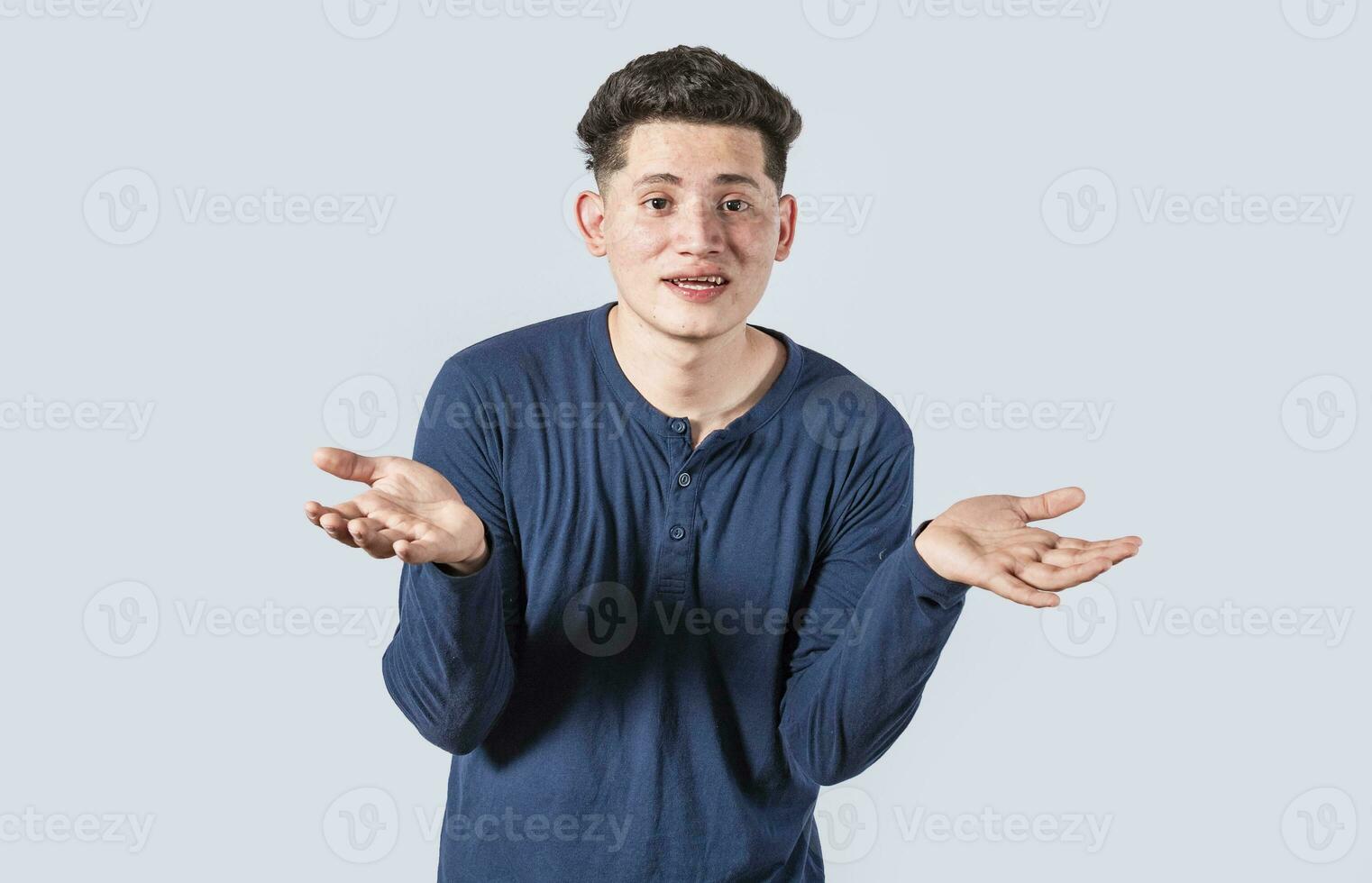 Man spreading palms, feeling clueless and uncertain, man spreading hands bewildered, concept of a puzzled man photo