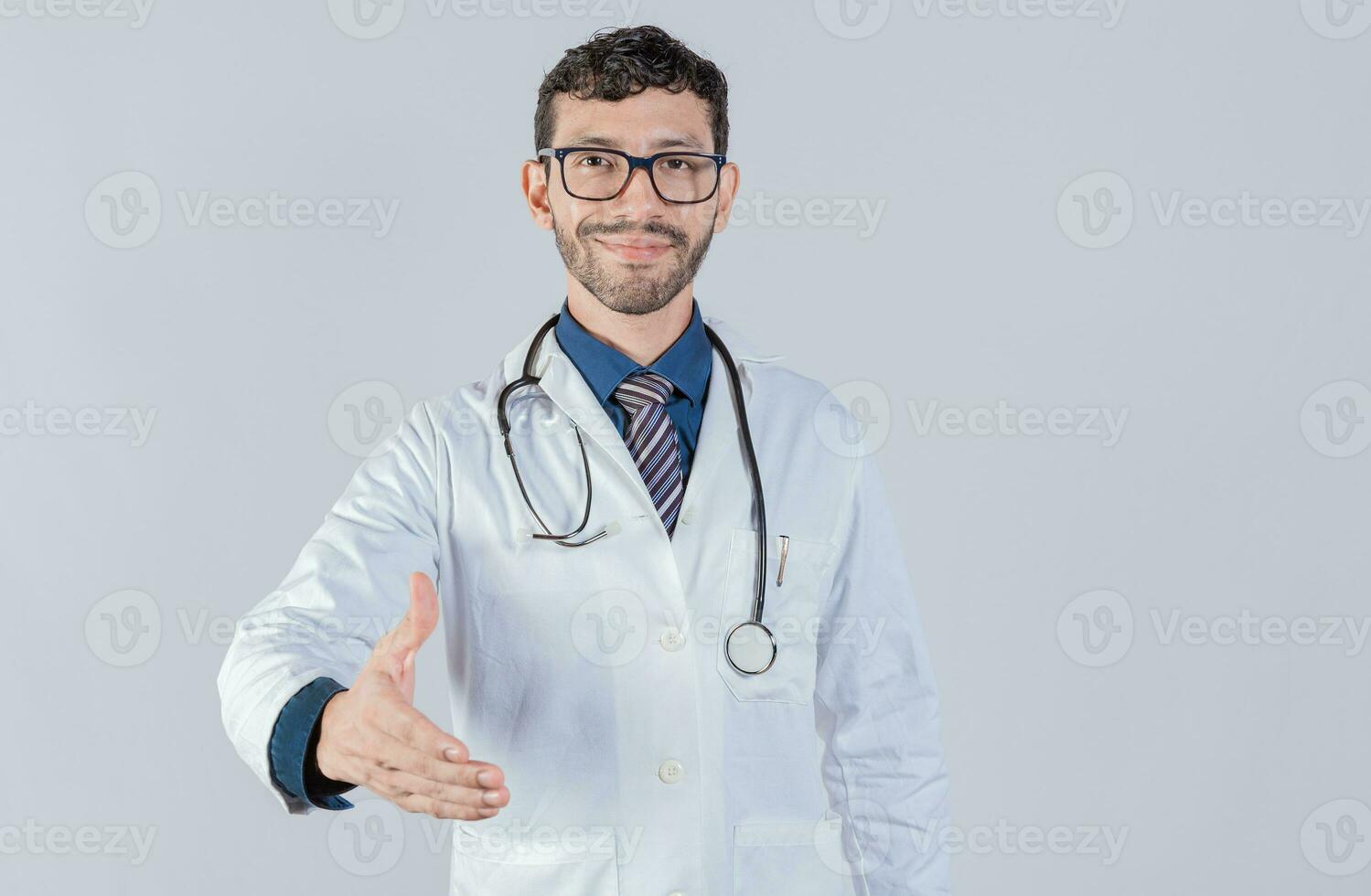 Smiling doctor shaking hands in welcome sign isolated. Friendly male doctor extending hand to camera isolated photo
