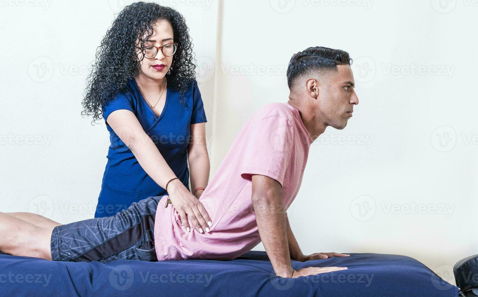 Physiotherapist performing lumbar physiotherapy to patient, Physiotherapist with patient performing lumbar treatment, lumbar physiotherapy concept photo