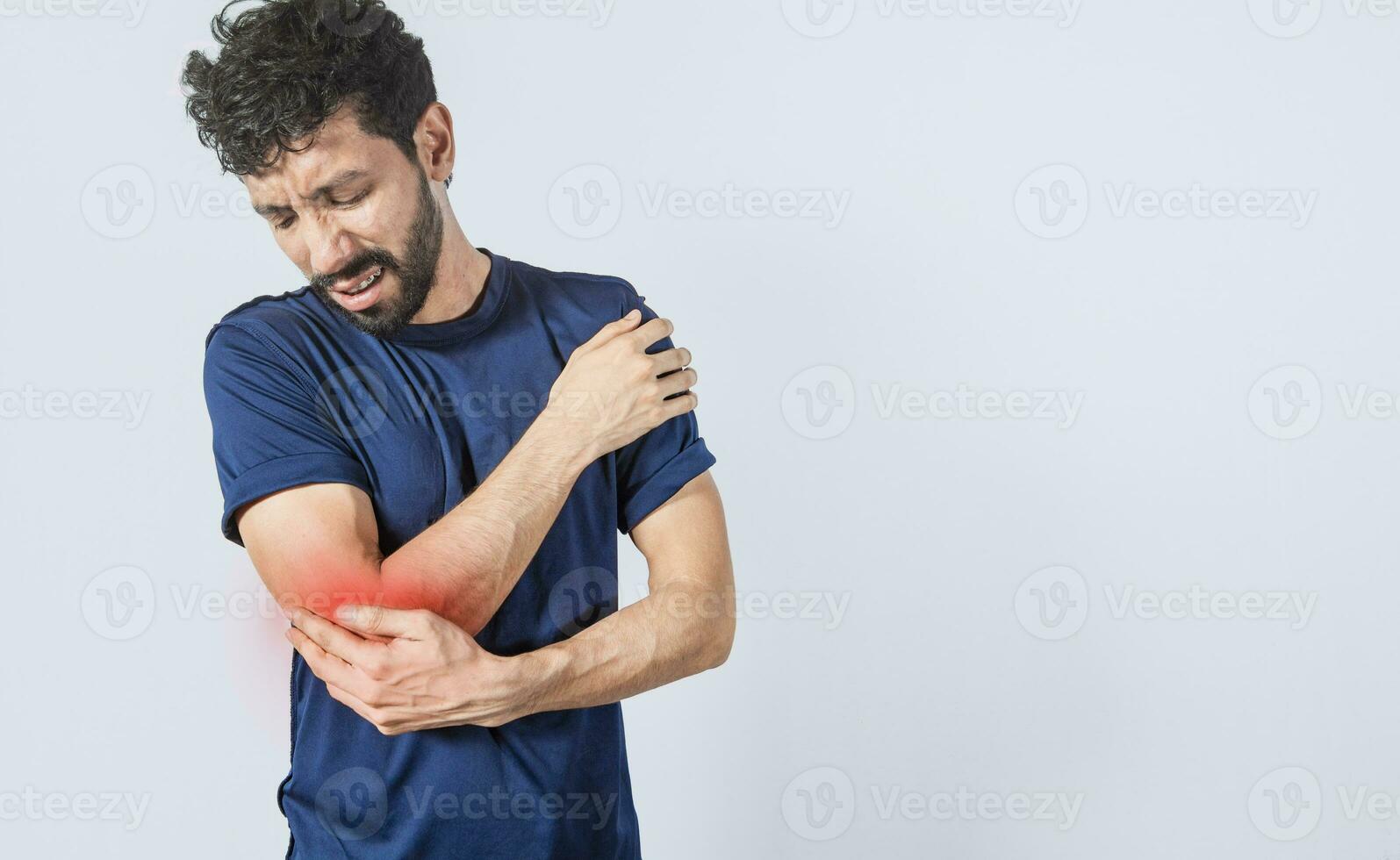 Person with elbow pain, concept of a man with rheumatism elbow pain, man massaging sore elbow, man with elbow cramp photo