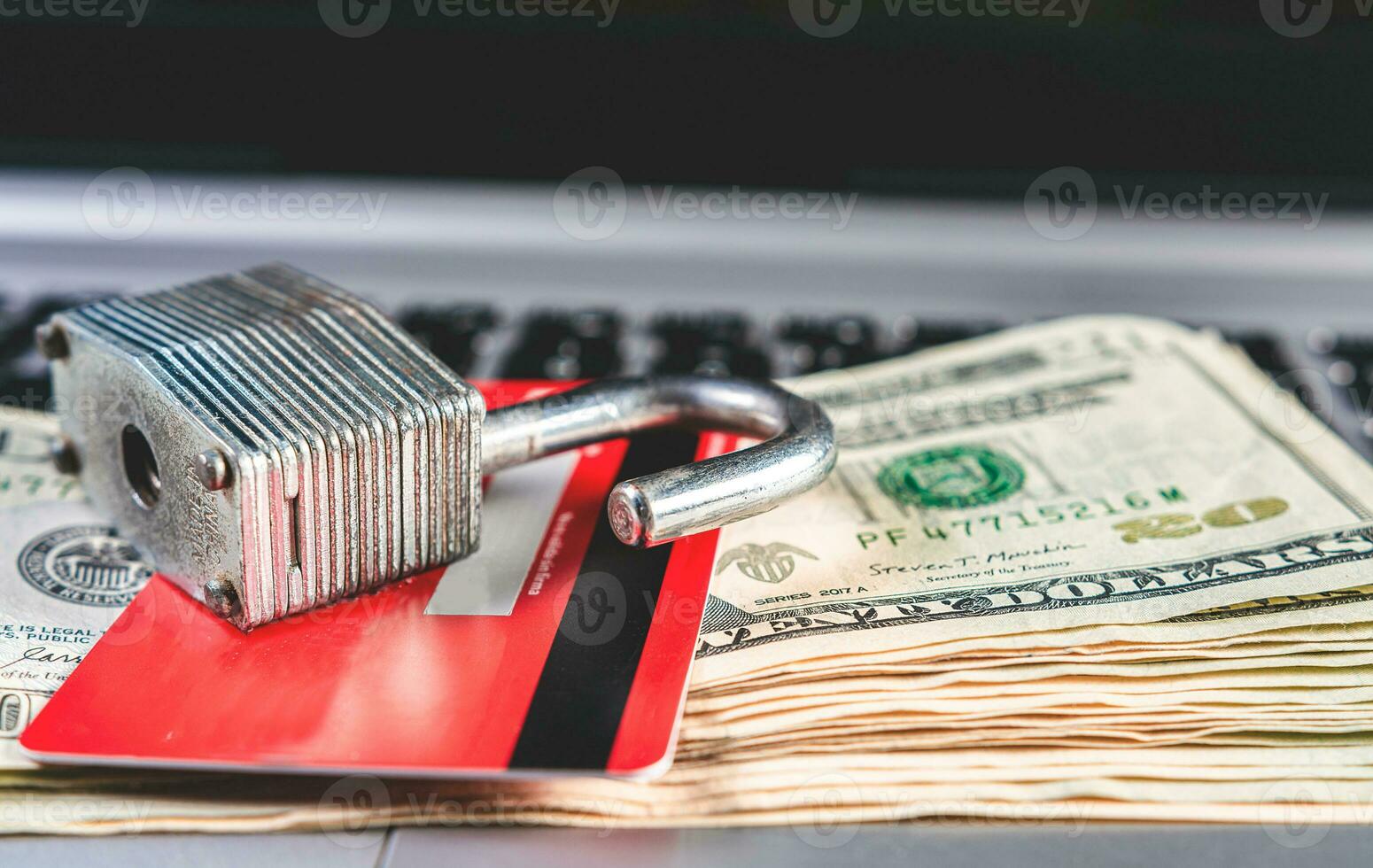 Concept of online payment with card, security and finance. Open padlock with credit card and dollar bills photo