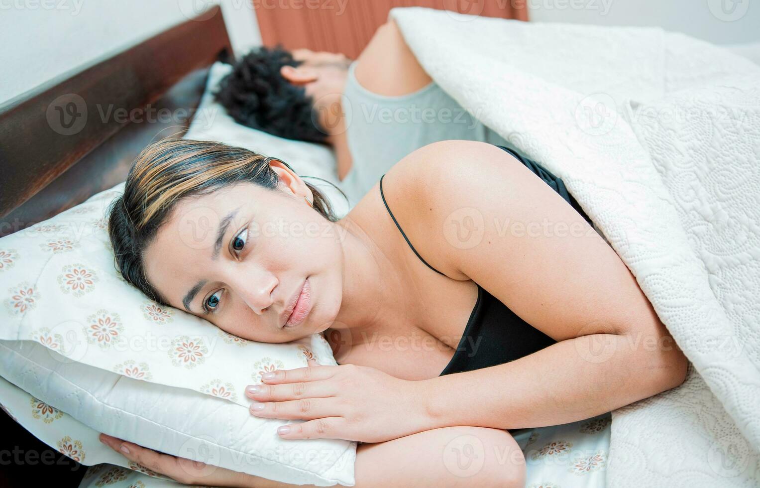 Young couple arguing and sleeping apart. Concept of couple problems in bed. Unhappy couple in bed sleeping apart, Upset couple sleeping on their backs photo