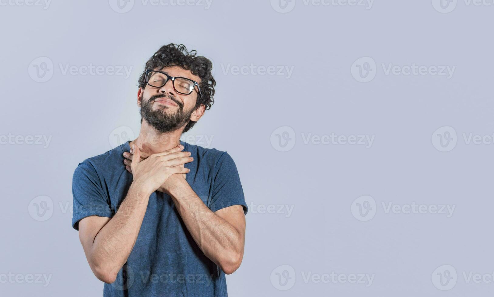 Relaxed person with thanks gesture with hands on chest. Grateful people smiling with hands on chest. Positive looking friendly handsome man with charming sincere smile feeling thankful photo