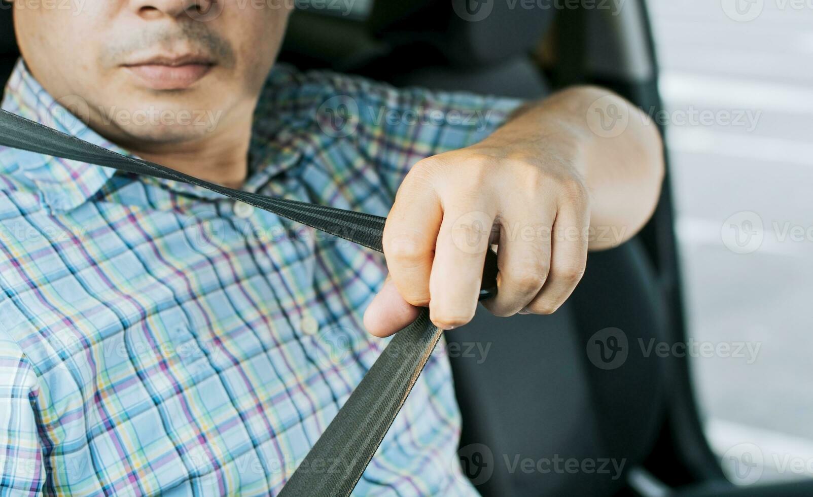 Safety belt for accident prevention. Driver hands fastening the seat belt, Close up of person hands putting on the seat belt. Driver's hands putting on the seat belt photo