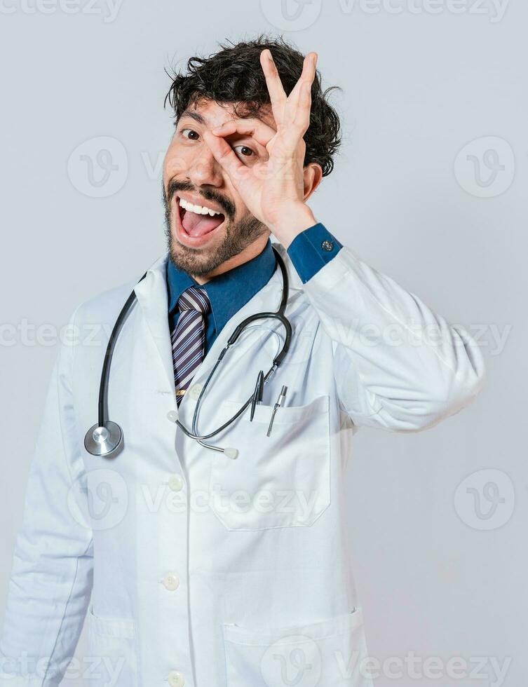 Happy doctor gesturing approval isolated, Latin doctor approving on isolated background. Handsome doctor approving and recommending isolated photo