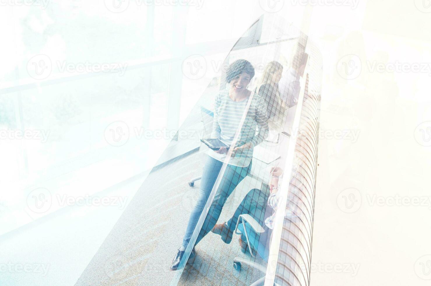 Pretty Businesswomen Using Tablet In Office Building during conference photo