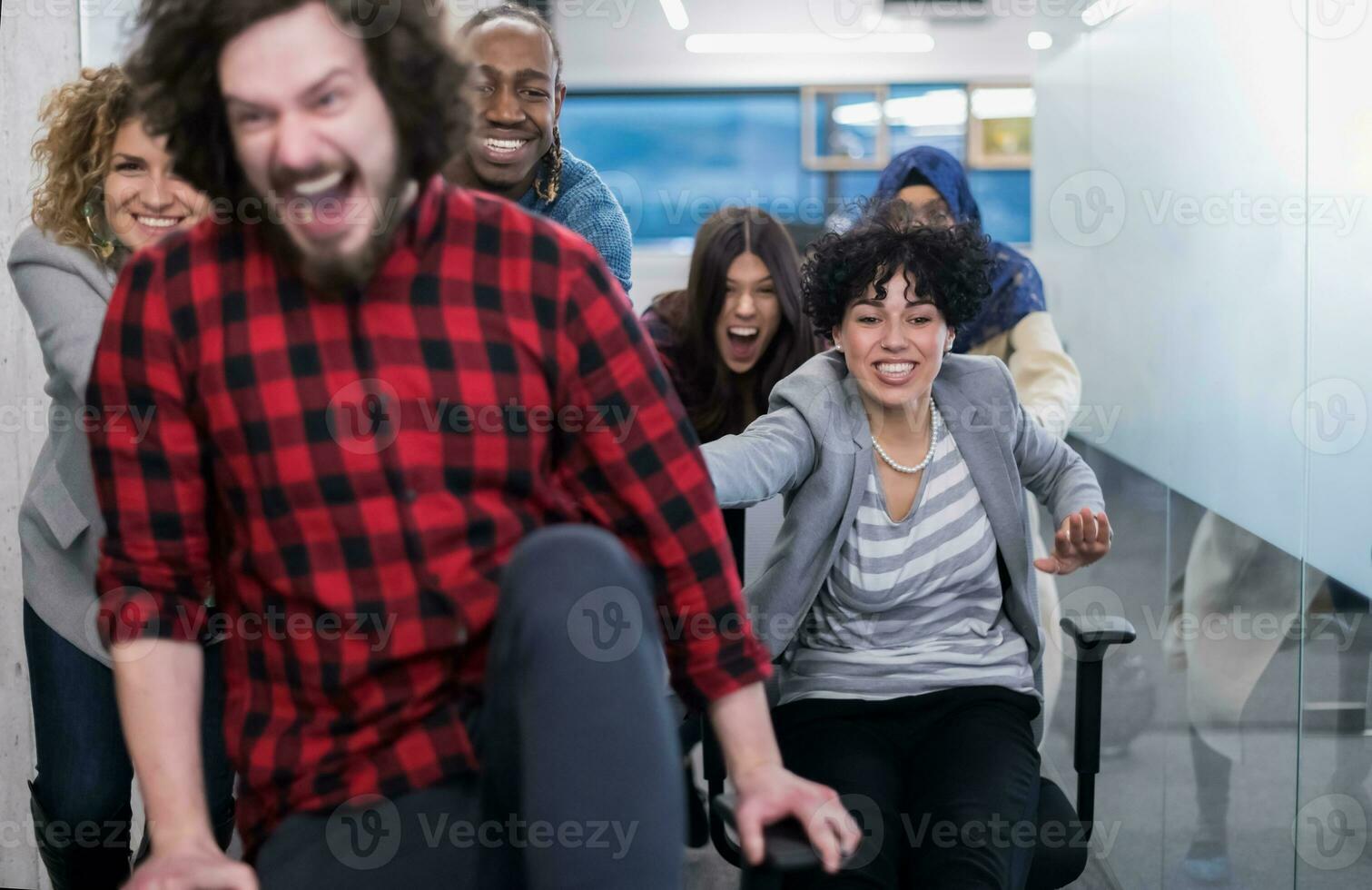 multiethnics business team racing on office chairs photo