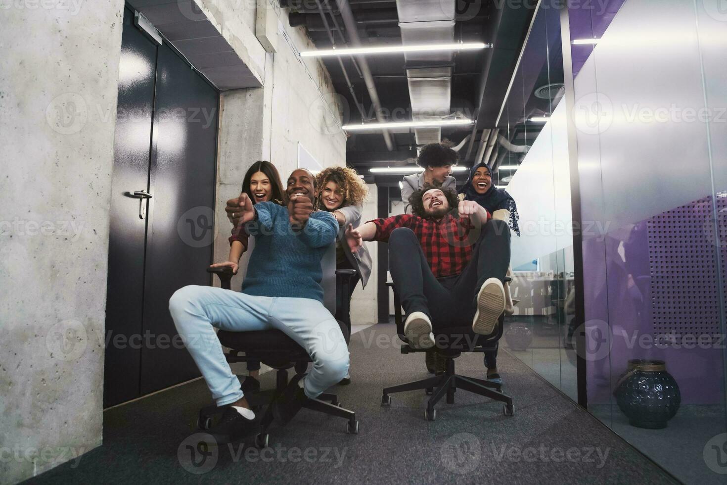 multiethnics business team racing on office chairs photo