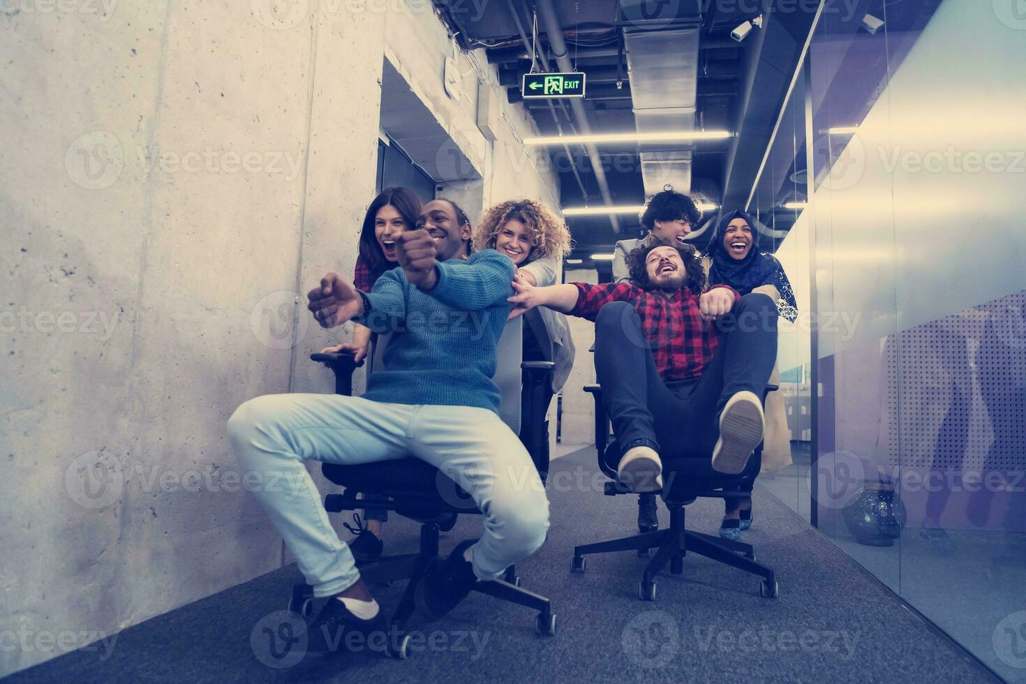 multiethnics business team racing on office chairs photo