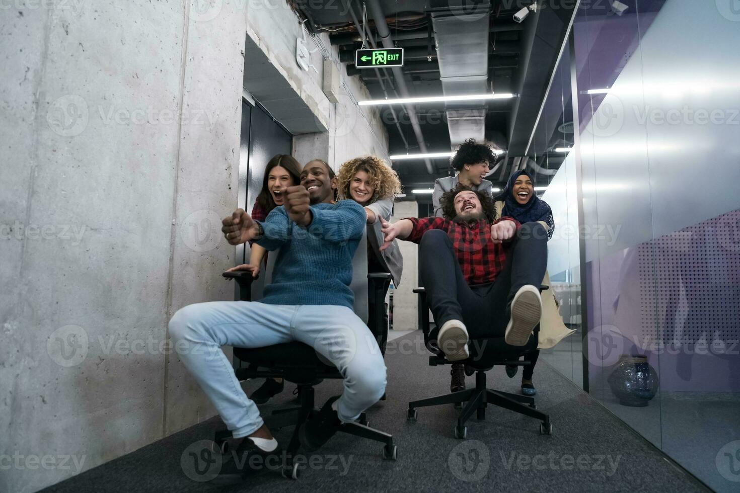 multiethnics business team racing on office chairs photo