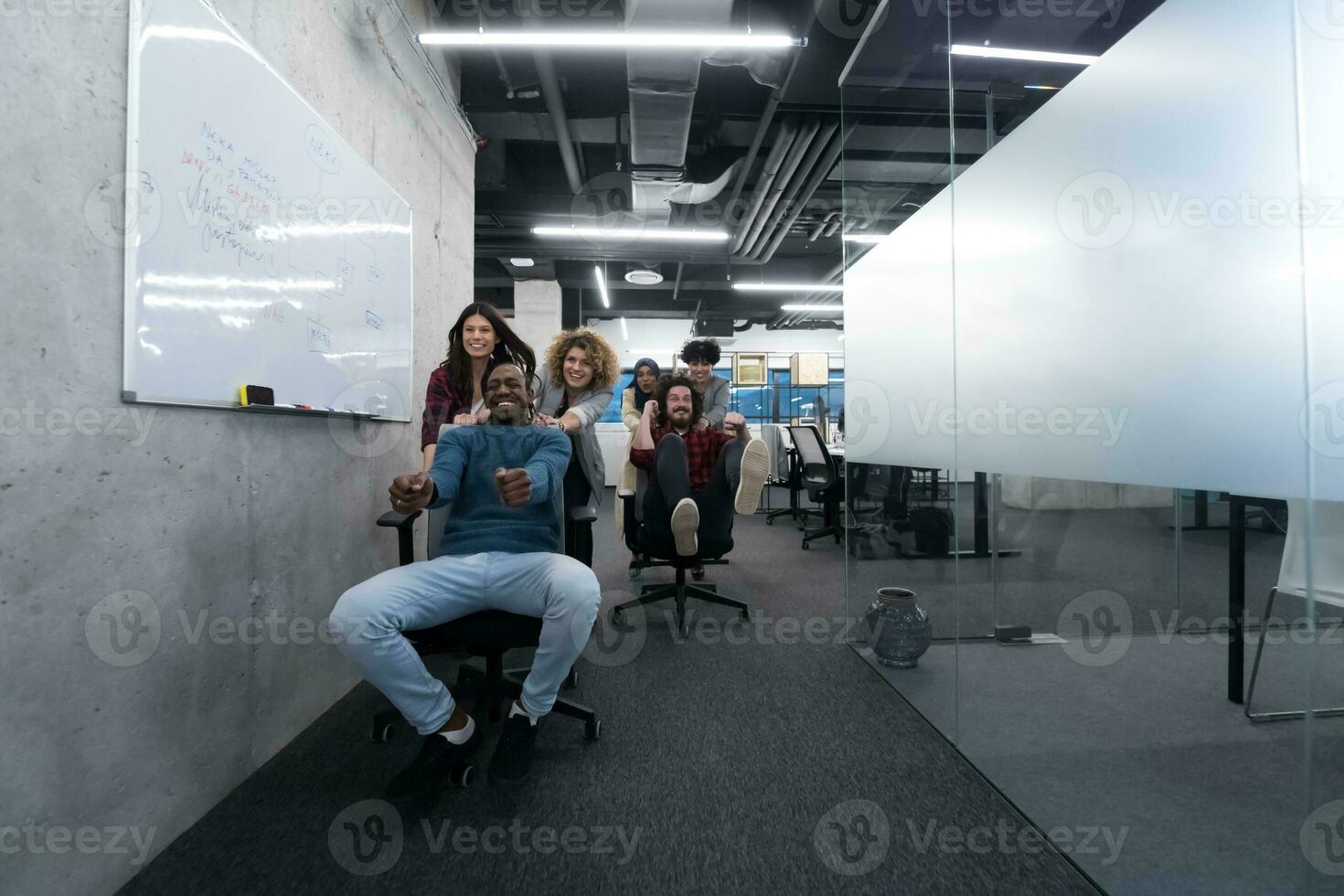 multiethnics business team racing on office chairs photo
