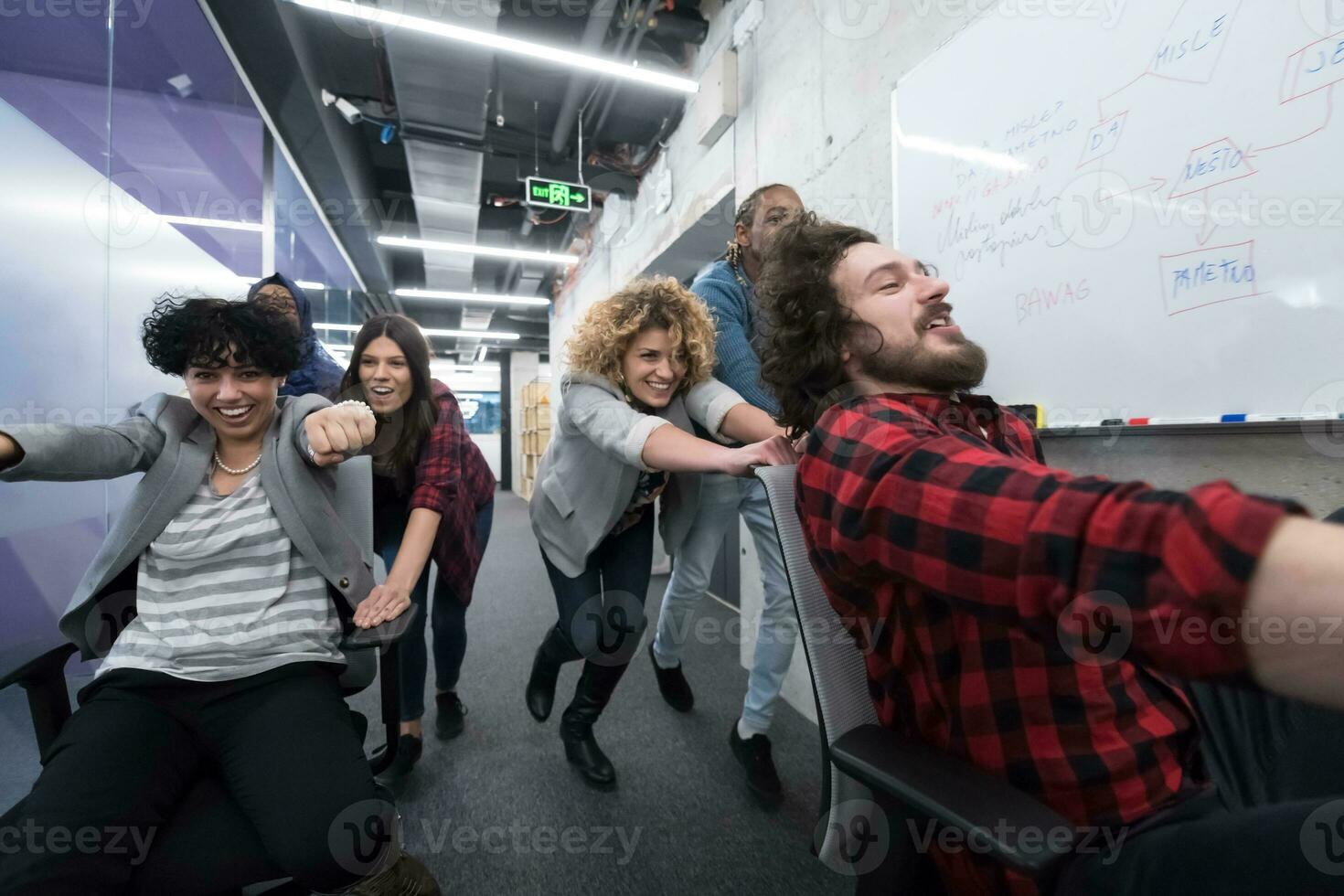 multiethnics business team racing on office chairs photo