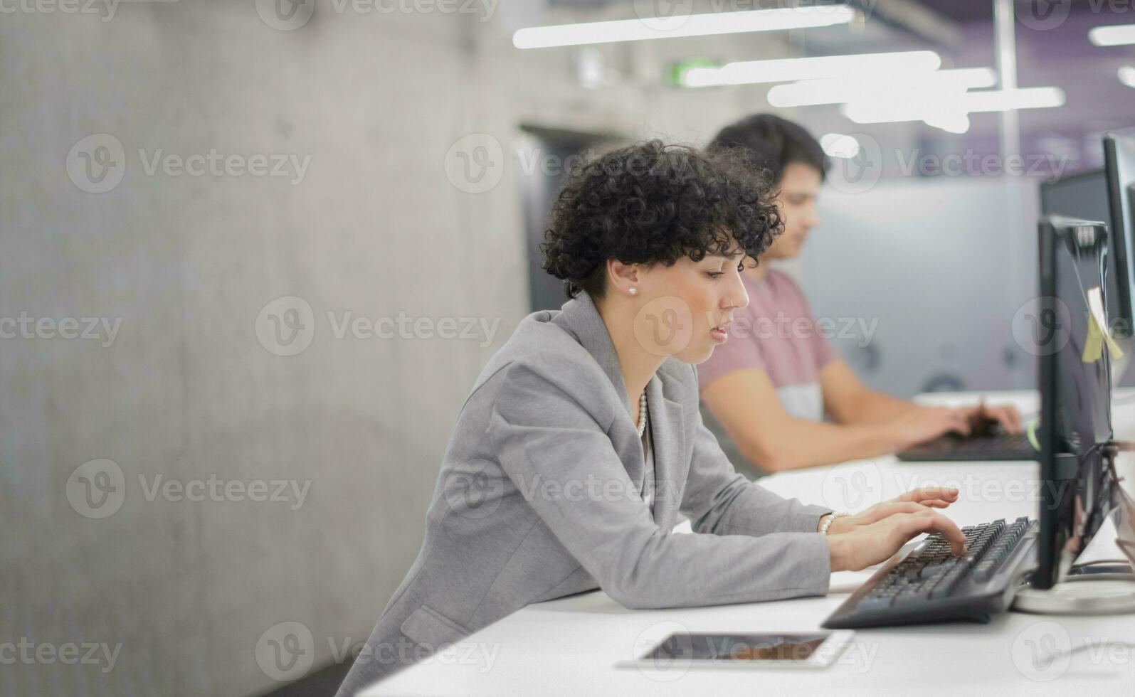 female software developer using desktop computer photo