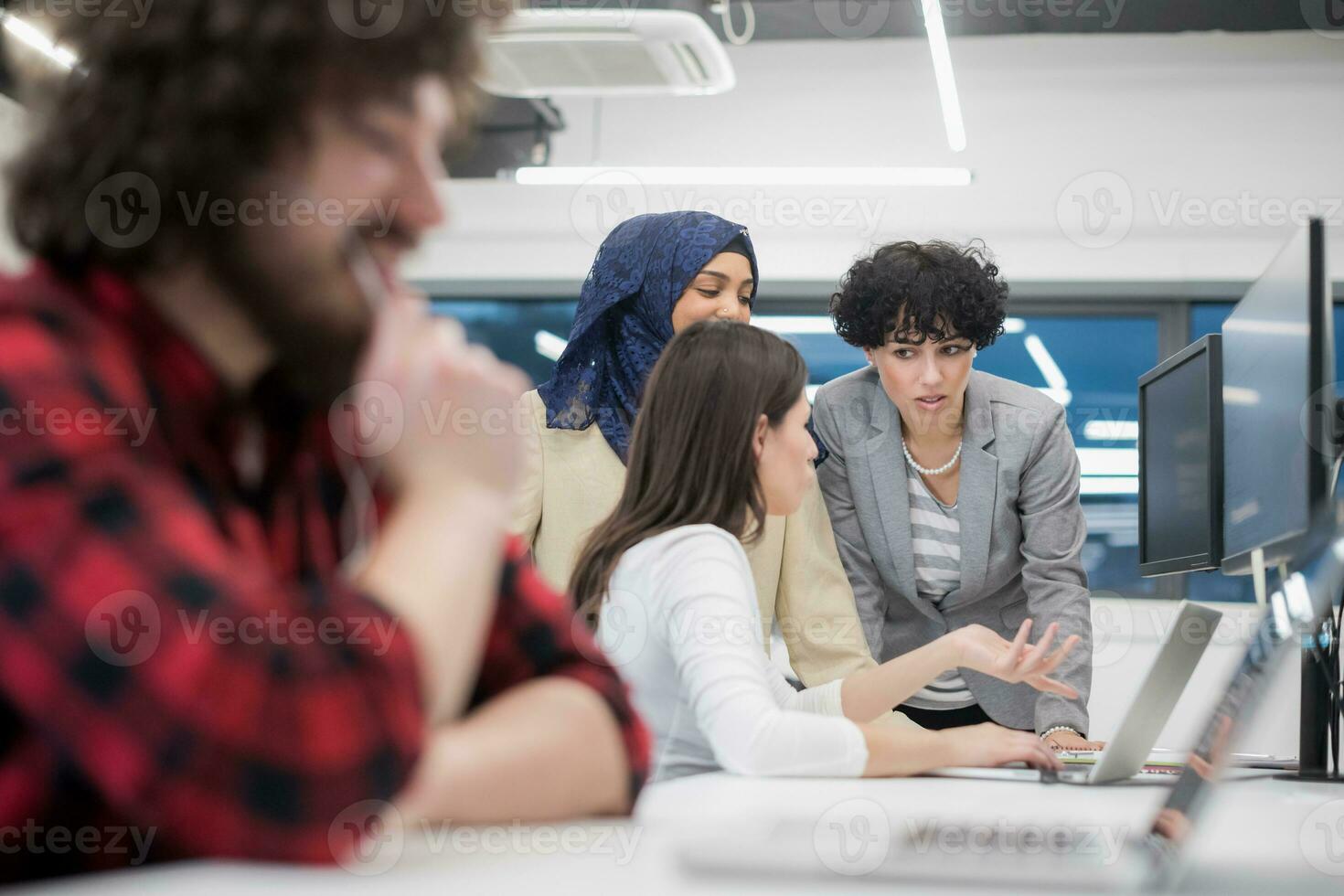 young multiethnics team of software developers working together photo