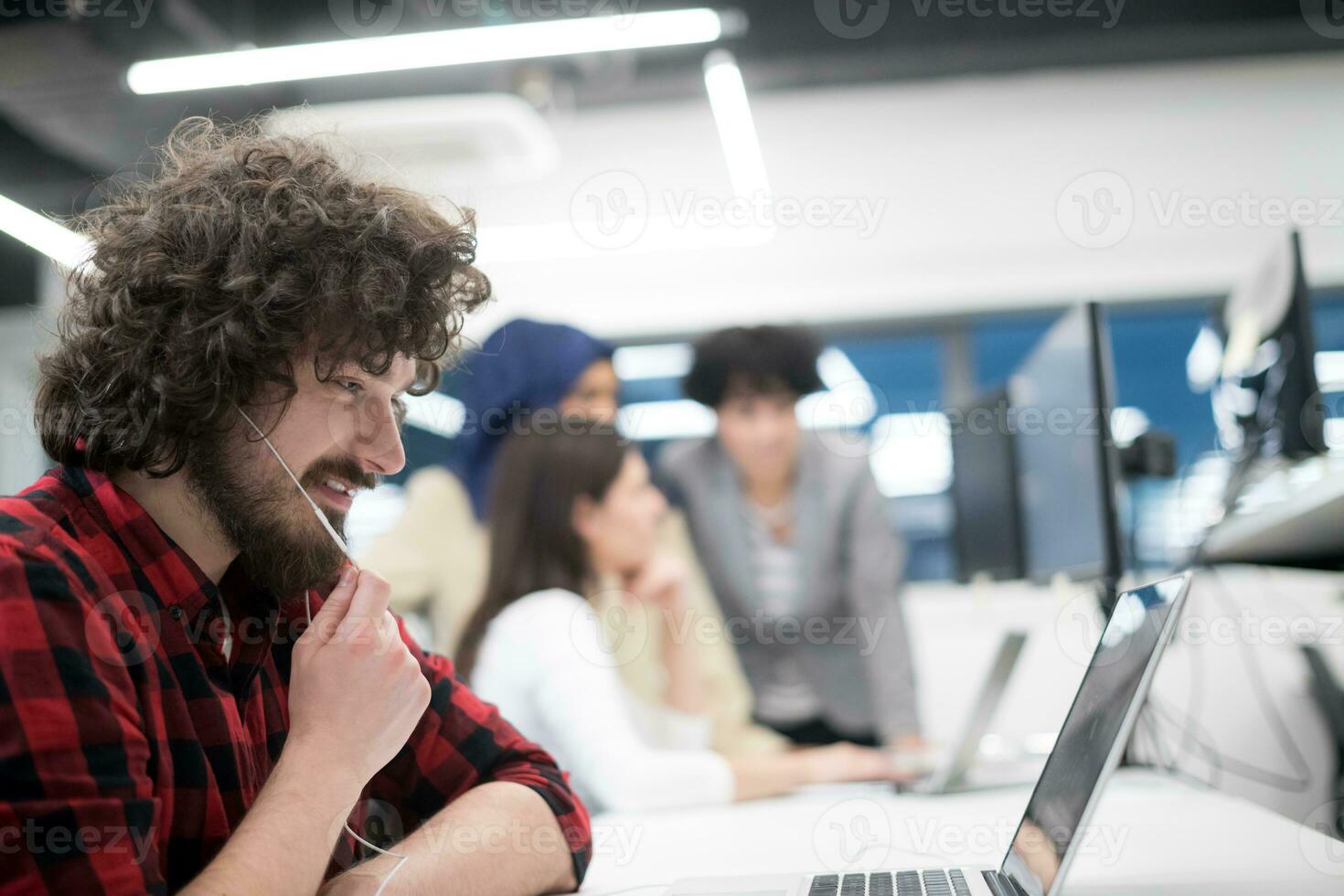 young multiethnics team of software developers working together photo