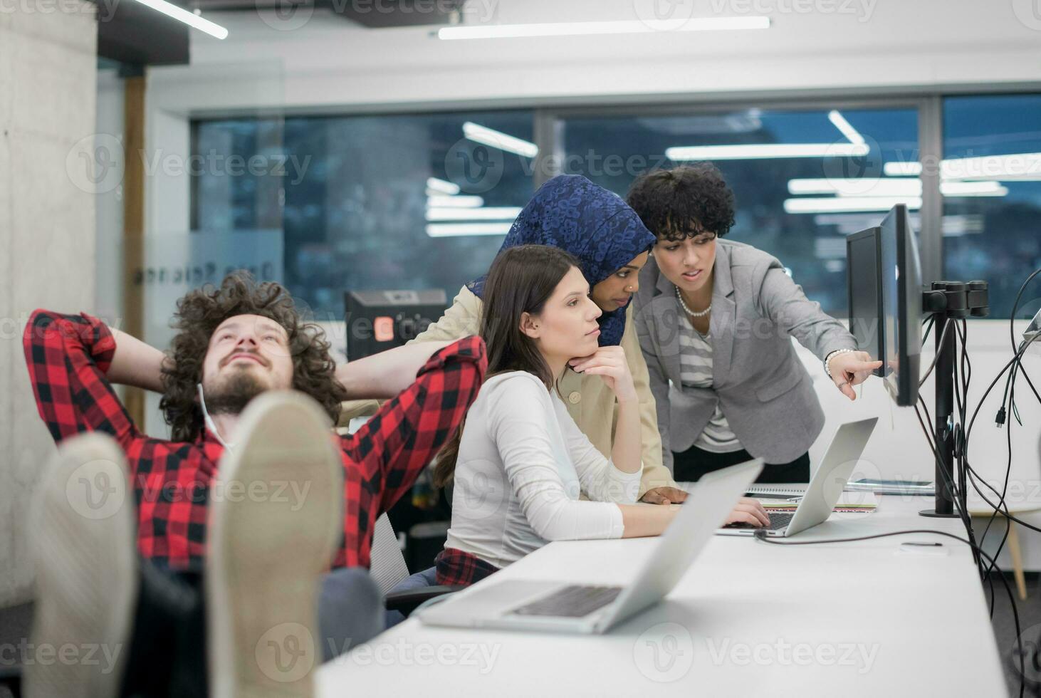 software developer resting with legs on desk photo